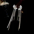 Elegant moon-shaped tassel ear cuffs with shimmering crystals and dangling silver chains. - Moon Star Tassel Ear Cuff (50)
