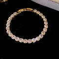 Detailed view of luxury 18k gold plated tennis bracelet with sparkling cubic zirconia - Gold-White