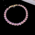 Close-up of 18k gold plated bracelet with sparkling purple zircons and snap clasp. - Silver-Purple
