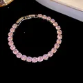 Elegant tennis bracelet featuring sparkling pink round-cut zircons on a dark surface - Silver-Pink
