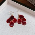 Elegant deep red water-drop petal dangle earrings with polished golden hooks for women. - Owl Hollow Water Drop (HE23805) / Gold-Red