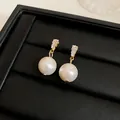 Close-up of vintage gold pearl earrings with sparkling rectangular stones on black box - Trapezoid Shape / Gold