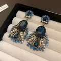 Detailed view of vintage drop earrings featuring dark blue crystals and elegant white pearls - Silver Earring Post Teardrop Earrings / Blue
