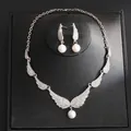 Detailed shot of an elegant angel wing jewelry set featuring rhinestones and white pearls - Necklace And Earrings Set (7#) / Silver Angel Wings
