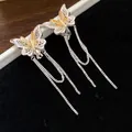 Detailed view of 18k gold plated butterfly clip-on earrings with long tassels - Silver-Gold
