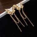 Detail of 18k gold plated butterfly ear clips with long elegant tassel chains - Gold-Silver