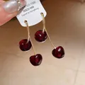 Detail of vintage dark red resin cherry earrings with gold finish stems and tag - Silver Earring Post - Red