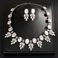 Elegant silver-tone necklace and earrings set with clear oval rhinestones on black stand. - Necklace And Earrings Set (24#) / Silver-White Rhinestone