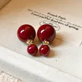 Close-up of Ankara red double ball stud earrings with glossy finish - Double Bead Stud Earrings (6#)