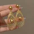 Glossy gold multi-layered teardrop hook earrings with a central pendant tassel detail - Multi-Layer Hollow Teardrop Style (47#) / Silver Needle / Gold