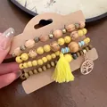Detail of Bohemian 4-piece beaded bracelet set with yellow tassel and Tree of Life charm - Tree of Life Pendant Style (18#) / Yellow