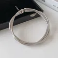 Close-up of silver multi-layer snake chain necklace in minimalist metal style - Silver
