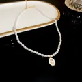 Elegant faux pearl necklace featuring an oval floral pendant on a minimalist reflective display - Oval Tulip Style (3#)