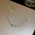 Detailed close-up of a sparkling gold-plated adjustable bracelet with zircon stones - 1. Real Gold Plated With Zircon Stones Bracelet.