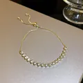 Detailed view of an adjustable gold pull-out bracelet with sparkling zircons. - 6. Genuine Gold Plated With Zircon Stones Bracelet.