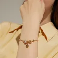 Elegant gold charm bracelet with sparkling zircon beads and a heart-shaped pendant - 17. Gold Waist Style Bracelet
