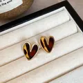 Close-up of vintage heart stud earrings with leopard print and gold-tone finish. - Heart Leopard Gold Frame (66#) / Gold Brown
