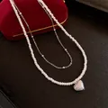 Layered necklace with textured heart pendant and white pearl beads in silver finish - Pearl Layered Style