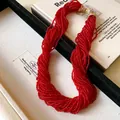 Close-up of red multi-strand beaded necklace with a sparkling diamond magnetic clasp. - Multi-layer Beaded Clavicle Chain (HN7442) / Gold-Red