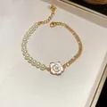 French retro pearl and rhinestone bracelet with a dainty white camellia flower charm. - Camellia Patchwork Style / Gold
