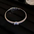 Detailed view of sparkling zircon-encrusted silver bangle featuring an elegant center stone. - Silver