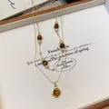 Detailed view of vintage tiger eye beaded double-layer necklace with gold pendant - Coffee-Gold
