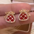 Close-up detail of red lucky bag earrings featuring faux pearls and sparkling cubic zirconia - Silver Post Red Lucky Bag Style (HE30077--1)