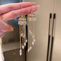 Élégantes boucles d'oreilles pendantes à pompon doré avec cristaux en forme de larme - Style Gland de Cristal (5)