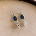 Vintage ethnic style silver-toned drop earrings with blue enamel center and metallic bud pendant. - Peacock Eye Enamel Style (HE20859-1)