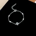 Silver bracelet with sparkling zircon flower charm and adjustable extension chain - Single Flower Zirconia Style / Silver