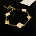 Detailed view of a gold clover bracelet with acetate and rhinestone petals. - Four-leaf Clover Patchwork / Gold
