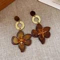 Detailed view of vintage resin flower drop earrings with tortoiseshell finish and crystals. - Resin Flower Pendant Style / Gold And Coffee