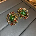 Vintage gold-tone earrings featuring a large green stone with faux pearl and crystal accents - Baroque Vintage Style (34#) / Green