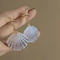 Elegant resin shell drop earrings with golden starfish studs for a vintage beach look - Starfish & Shell Style / White