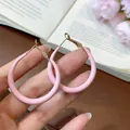 Elegant modern pink resin hoop earrings with gold-toned needles shown clearly on hand - Vintage Large Round Hoop Style (101) / Silver Needle Studs / Pink