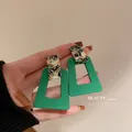 Vintage green geometric earrings with marbled patterns shown in a hand for scale and detail - Geometric Contrast Style (23#) / Avocado Green