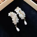 Elegant white flower earrings with teardrop pearls and 18K gold plated details - Small Flower Pearl Drop Style