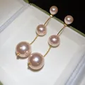 Close-up of elegant pink triple pearl drop earrings in a white jewelry gift box. - Three Pearl Drop Style / Gold-Pink