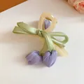 Detailed view of a sweet fabric tulip and bow acrylic hair claw clip on white surface. - Hair Claw / Green Purple