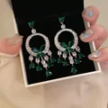 Elegant silver needle earrings featuring green stone butterflies and teardrop tassels. - Style 59 Butterfly Tassel (5942177792987) / Green