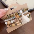 Detailed view of bohemian wood and stone beaded bracelet set with tree of life pendant. - 30# Bangle (30#) / White/Branch