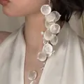 Statement cascading white resin disc earrings with faux pearl accents worn by model - Style 69 Ear Clip (5942177792994) / Single Piece / White