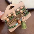 Close-up of bohemian style wood and green stone bead bracelet set with tree of life charm and tassel - 34# Bangle (34#) / Green/Branch