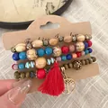 Detailed view of layered wooden and multi-colored beaded bracelets with red tassel charm - 37# Bangle (37#) / Red/Branch