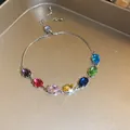 Adjustable silver bracelet with oval multi-colored zircons on a gold tray. - 12# Silver Multi-color