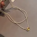 Close-up of elegant double-layer pearl necklace with vintage gold intertwining clasp - 42# Double Layer Necklace / 3mm Pearl / Gold-White