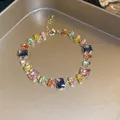Detailed view of a gold-plated bracelet with colorful rectangular zircon stones on a tray - 8# Gold Multi-color