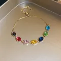 Detailed close-up of a gold-tone slider bracelet with vibrant multi-colored oval gemstones. - 11# Gold Multi-color