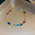 Detail view of a gold-tone bracelet featuring vibrant multi-colored oval zircons. - 1# Gold Multi-color