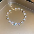 Detailed close-up of an elegant gold-tone bracelet featuring sparkling heart-shaped zircons - 4# Gold Clear